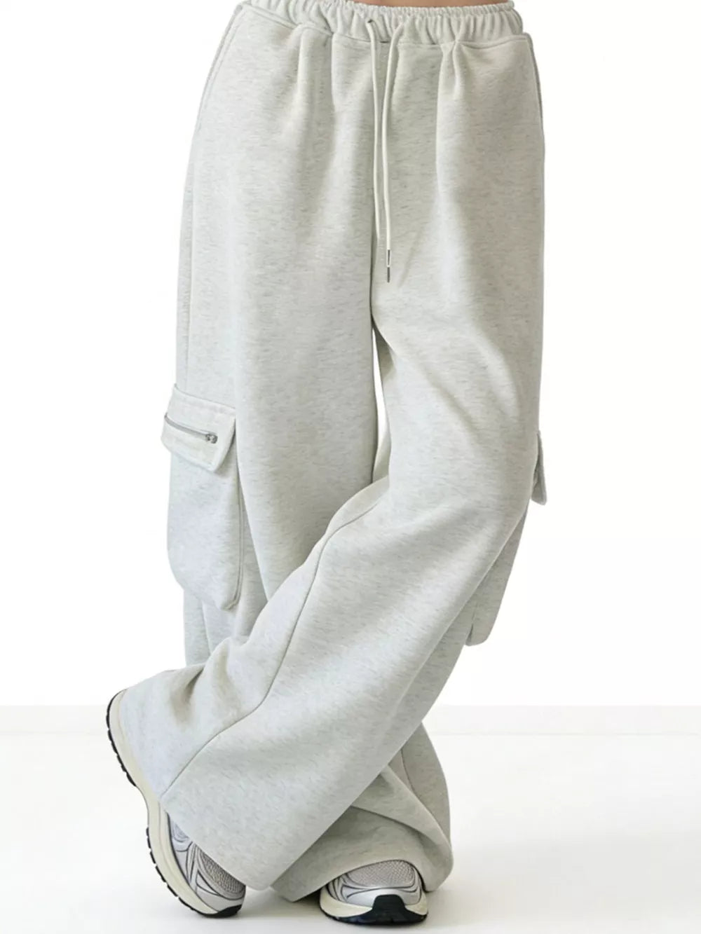 Gray cotton cargo sweatpants with drawstring and zippered pockets.
