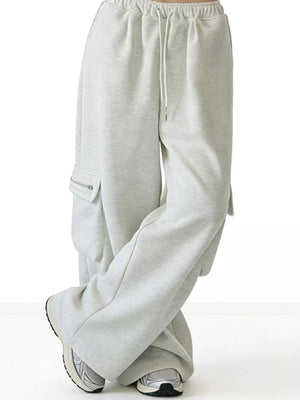 Gray cotton cargo sweatpants with drawstring and zippered pockets.