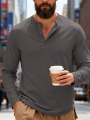 Men's gray long sleeve cotton henley t-shirt with button placket and textured fabric.
