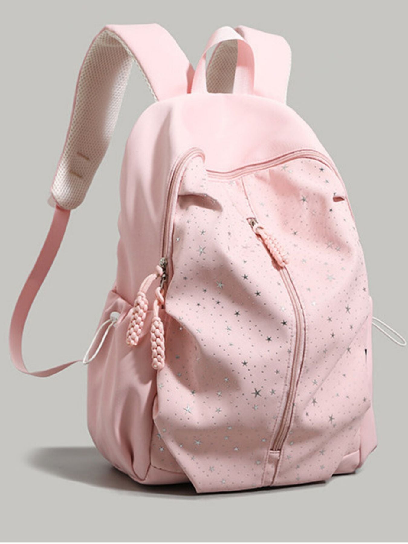 Pink nylon school backpack with silver star pattern and braided zipper pulls.