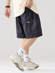 Navy blue 100% cotton relaxed fit cargo shorts with adjustable drawstring and side pockets.
