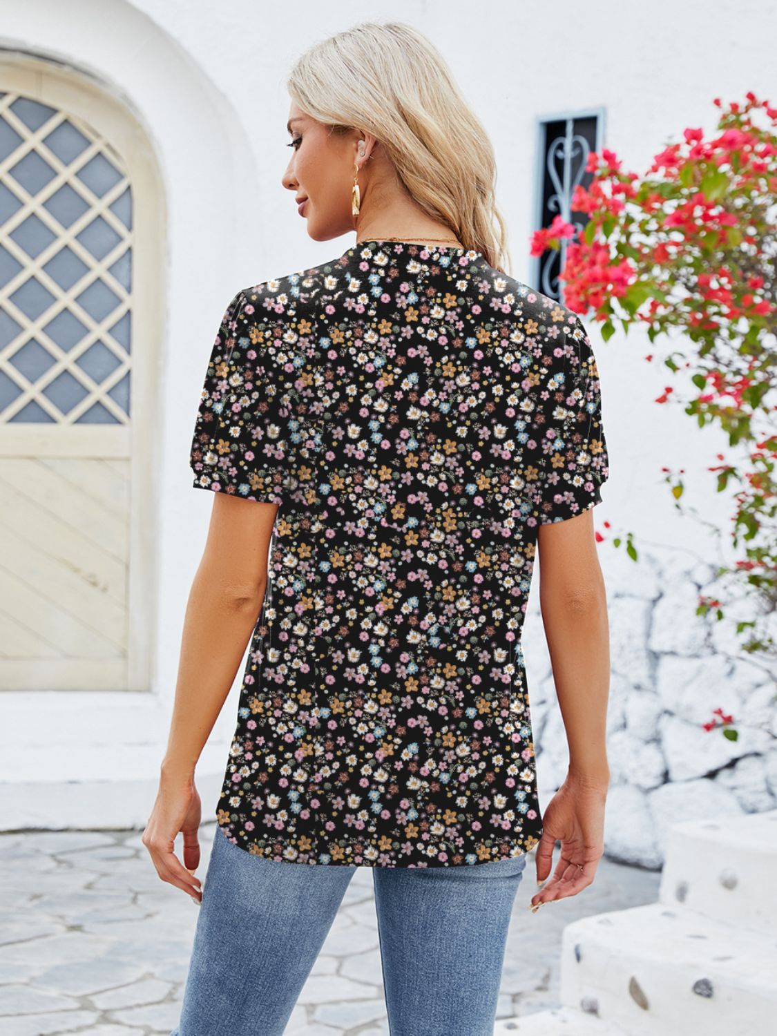 Black floral print blouse with short sleeves and a keyhole neckline.