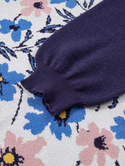 Patchwork sweater with floral design in floral color, featuring a navy blue sleeve and ribbed cuff.