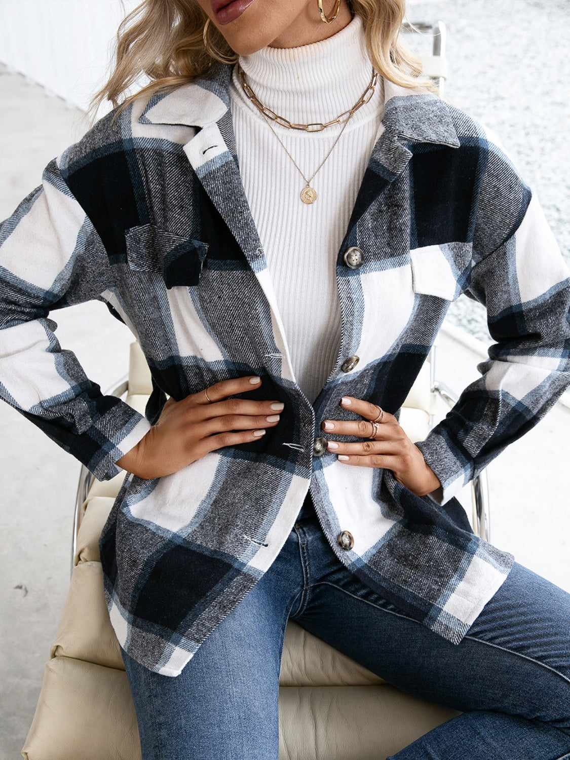Belted black plaid overshirt with patch pockets and button-down front.