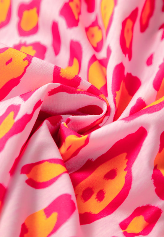 Pink leopard print blouse with balloon sleeves and button detail.