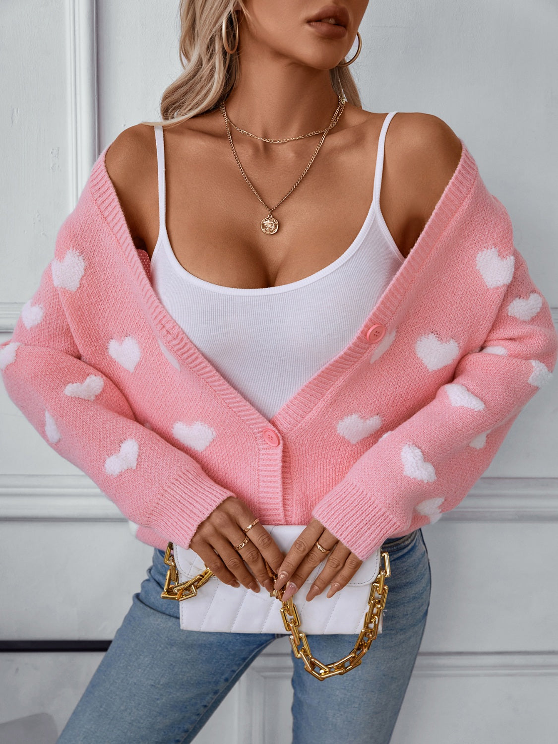 Blush pink acrylic knit cardigan with white hearts, button-front, V-neck