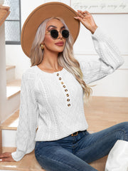 White cable knit henley sweater with button detail and diamond pattern.