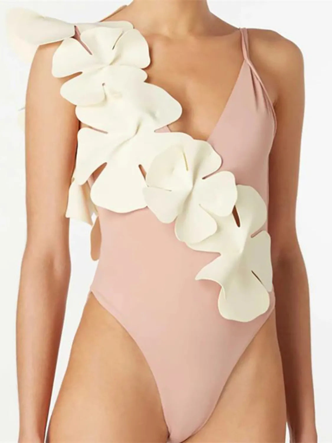Pale Blush one-shoulder swimsuit with sculptural petal applique detail.