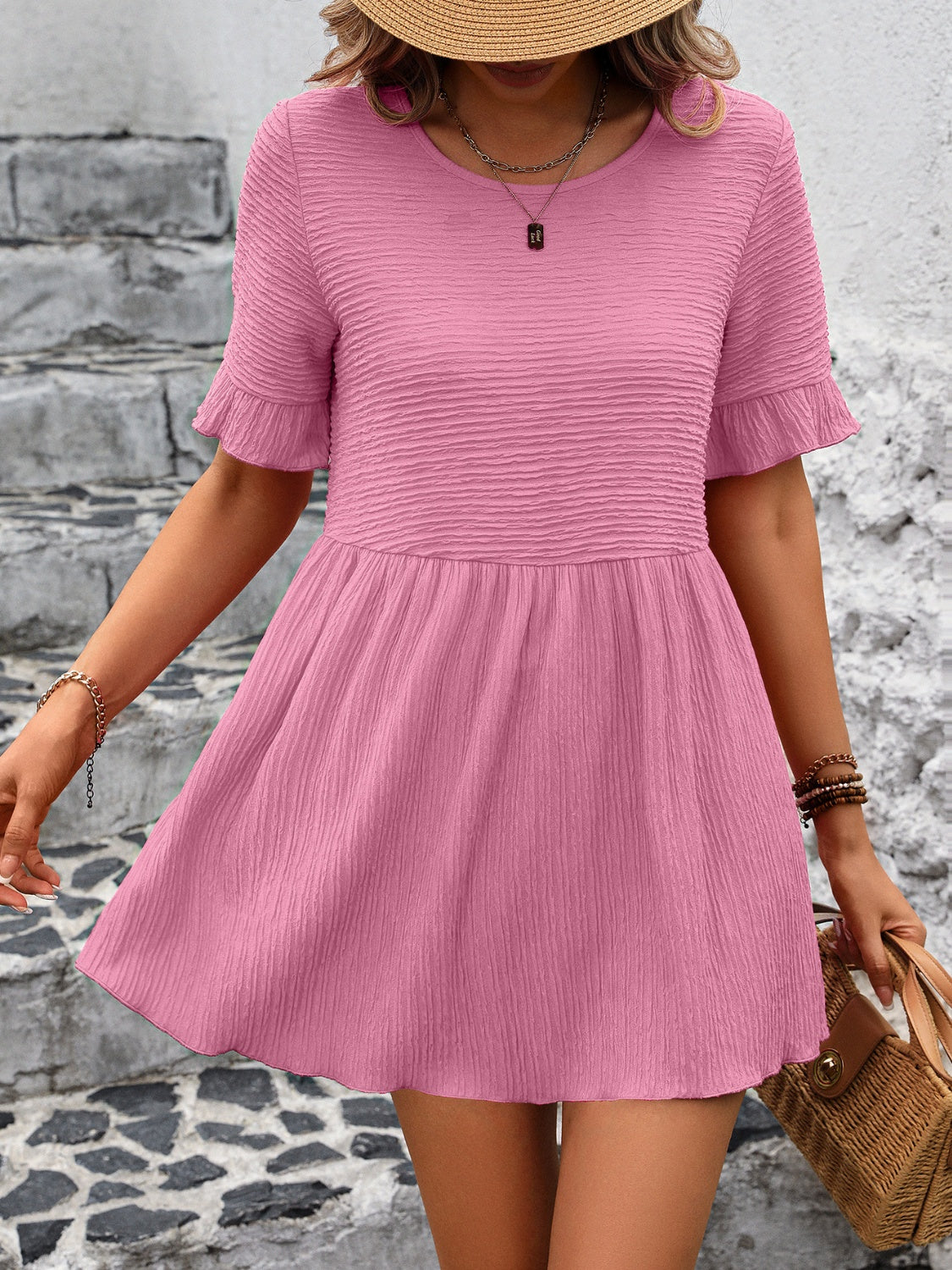 Blush pink textured babydoll blouse with flutter sleeves and a gathered waist.