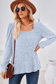Light blue ribbed square neck top with puffed sleeves and a textured knit.