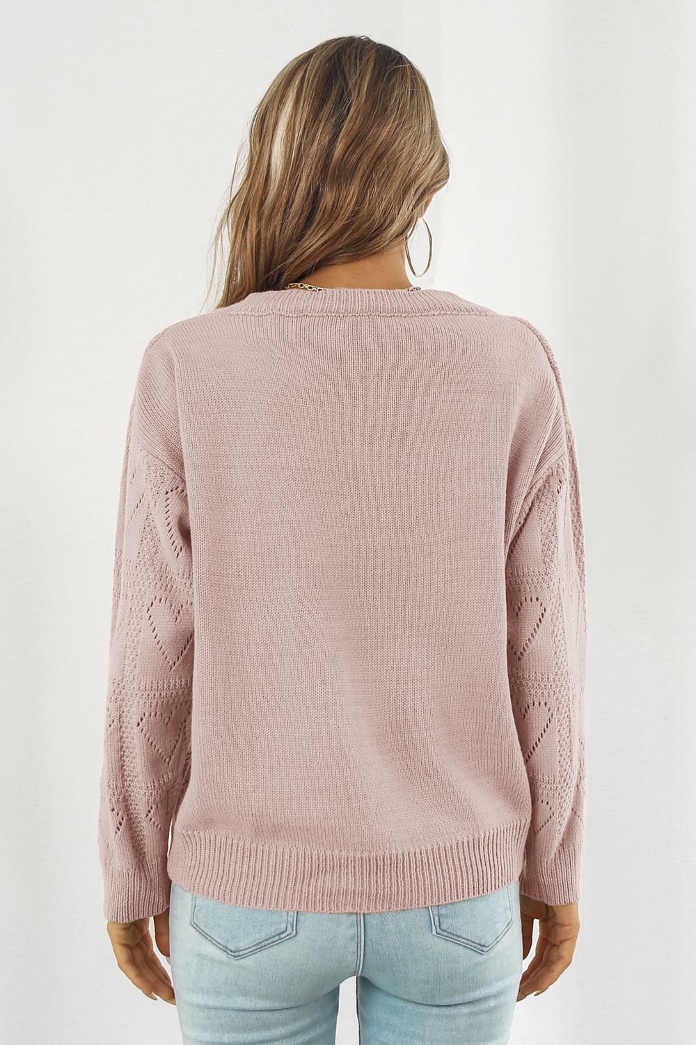 Dusty Pink acrylic V-neck knit pullover sweater with heart stitch detail on sleeves.