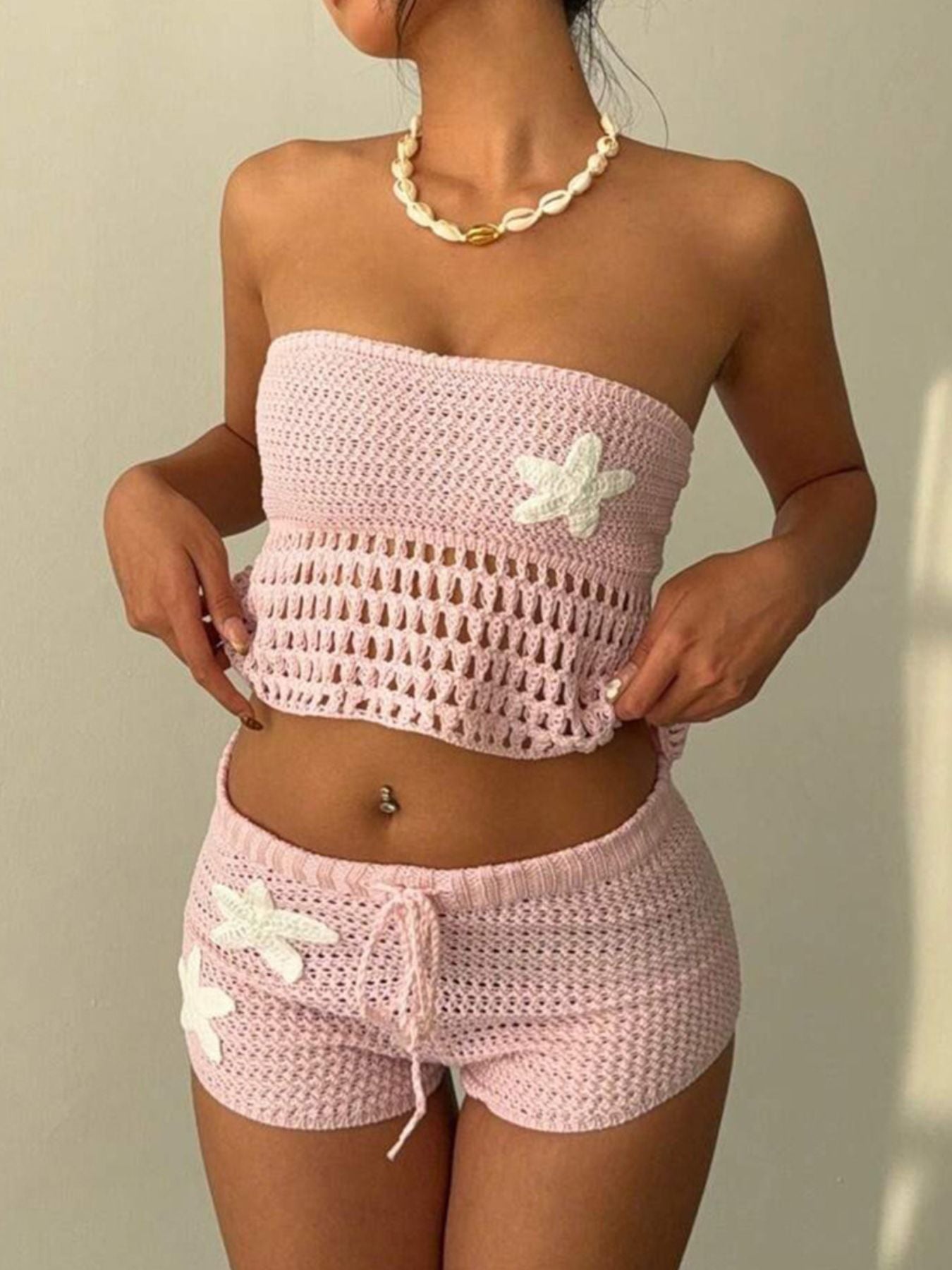 Pink crochet tube top and shorts set with flower appliques and drawstring shorts.