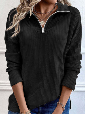 Black ribbed knit quarter-zip pullover sweater with a relaxed fit and silver zipper detail.