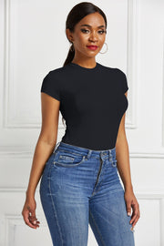 Black crew neck short sleeve bodysuit with a sculpted fit, paired with blue denim jeans.