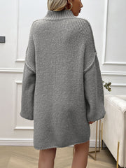 Gray knit mini dress with voluminous sleeves and a high neckline.