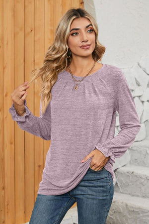 Lilac knit top with ruffled cuffs and pleated yoke detail.