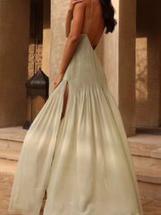 Sheer pleated maxi cami dress in light green with a high slit and open back.