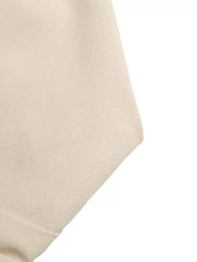 Cream pleated V-neck strapless romper fabric detail