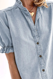Light blue denim blouse with ruffled collar and puff sleeves.