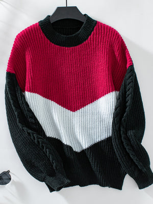 Chevron colorblock cable knit sweater in red, white, and black with cable knit sleeves.