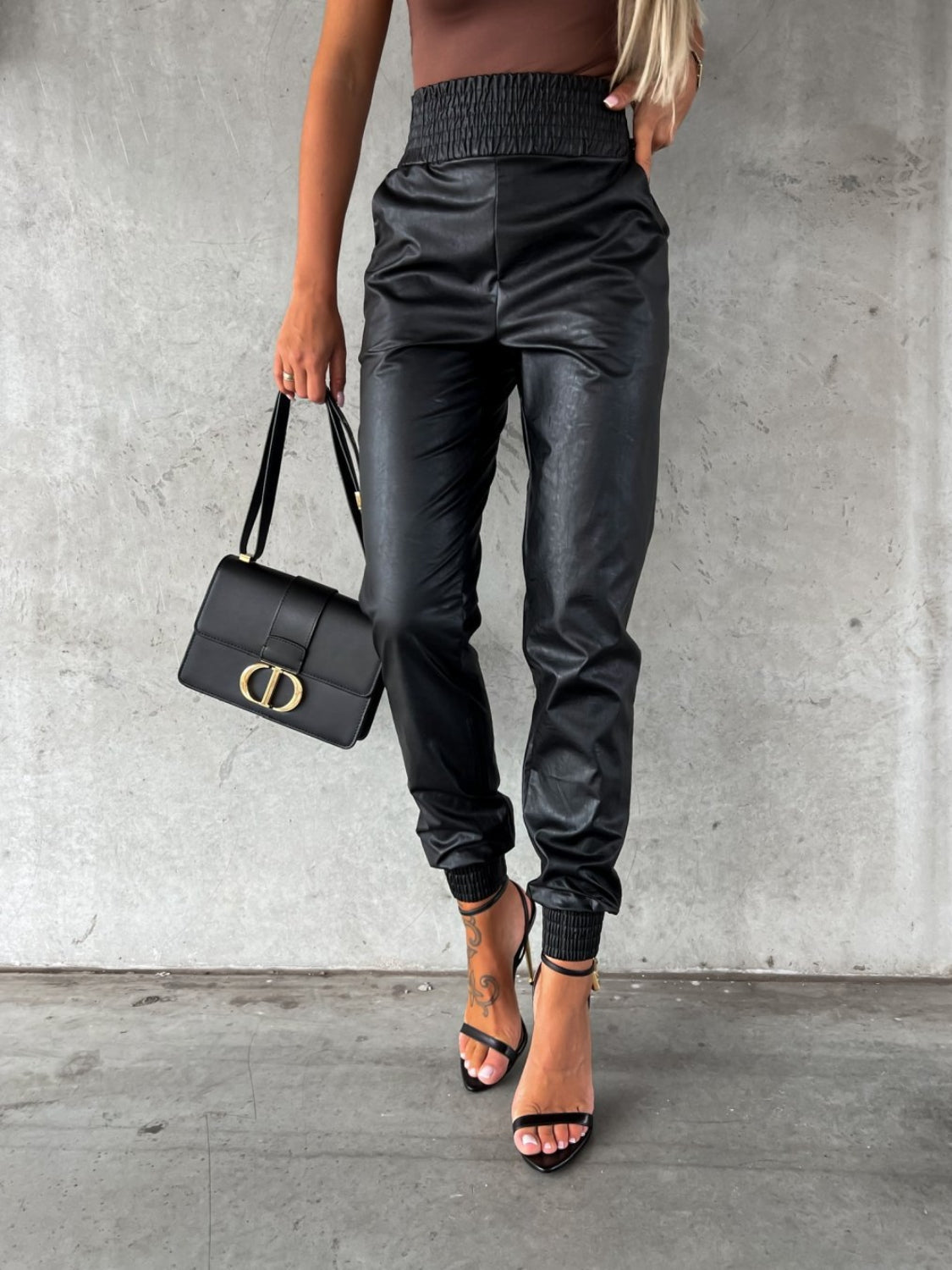 Black leatherette gathered waist joggers with cinched ankles.