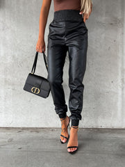 Black leatherette gathered waist joggers with cinched ankles.