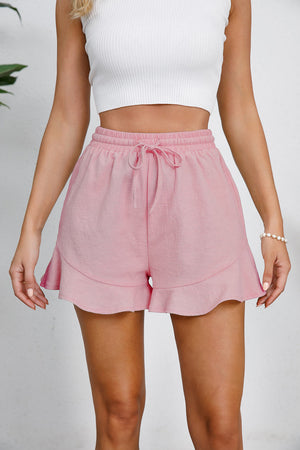 Blush pink linen blend shorts with drawstring waist and flounce hem detail