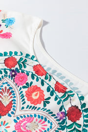 Embroidered medallion peplum blouse in floral print with ruffled neckline detail