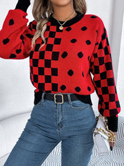 Red acrylic sweater with checkerboard and dot intarsia pattern, black trim and cuffs.