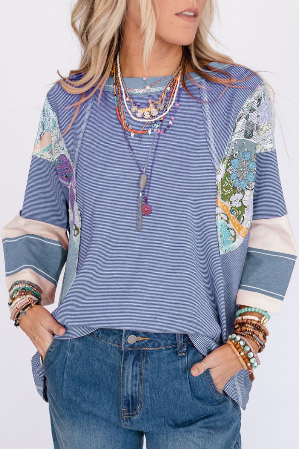 Patchwork stripe raglan sleeve tee in dusty blue with artistic floral panels and contrasting cuffs.