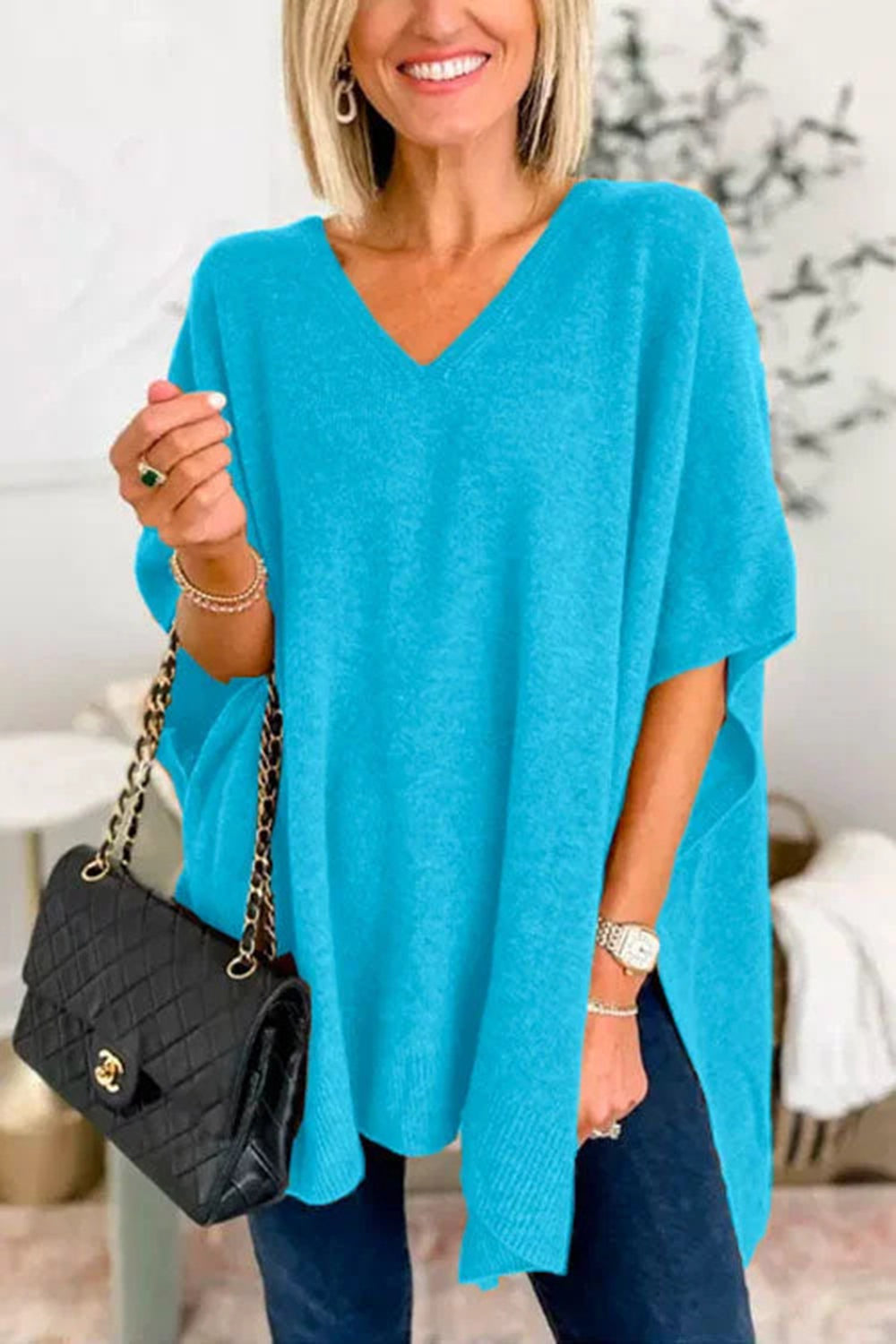 Cerulean relaxed V-neck knit poncho top with short sleeves and side slits.