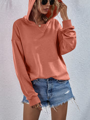 Boxy hooded sweatshirt in Tangerine with split neckline and cuffed sleeves.