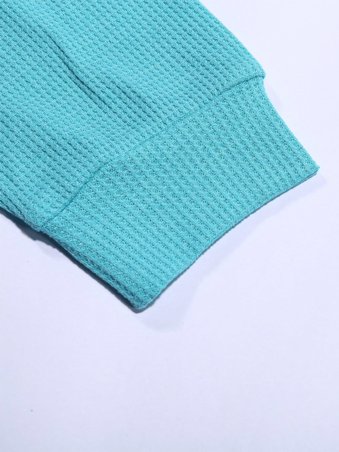 Pastel blue waffle knit crewneck top sleeve detail with ribbed cuff