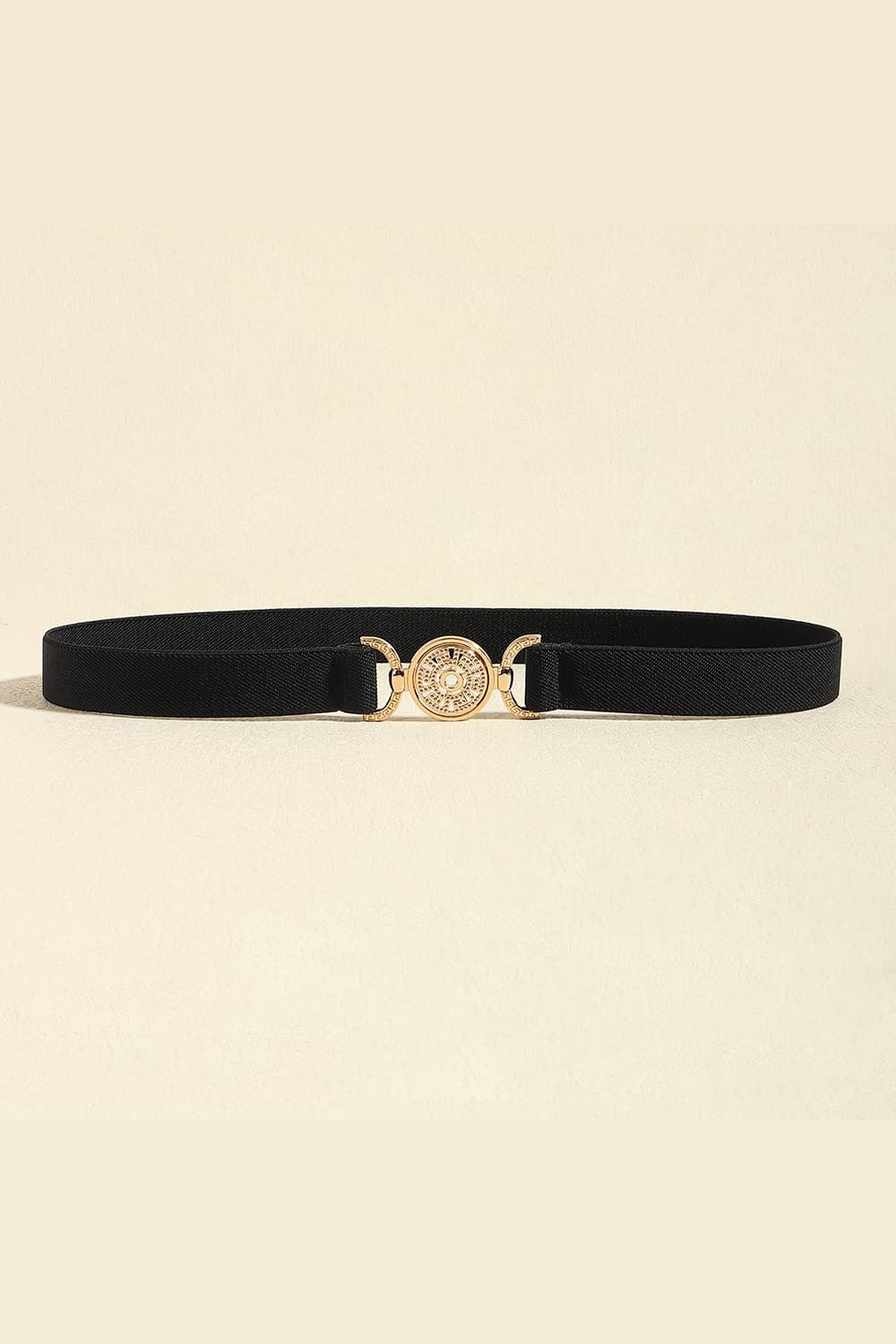 Black elasticated belt with a gold medallion buckle and alloy details