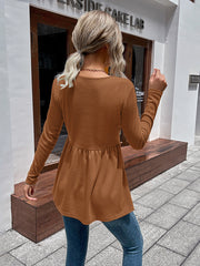 Caramel waffle knit peplum top with long sleeves and a gathered waist.