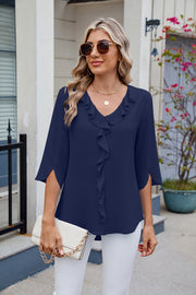 Dark blue V-neck flutter sleeve blouse with ruffled front detail and split sleeves.