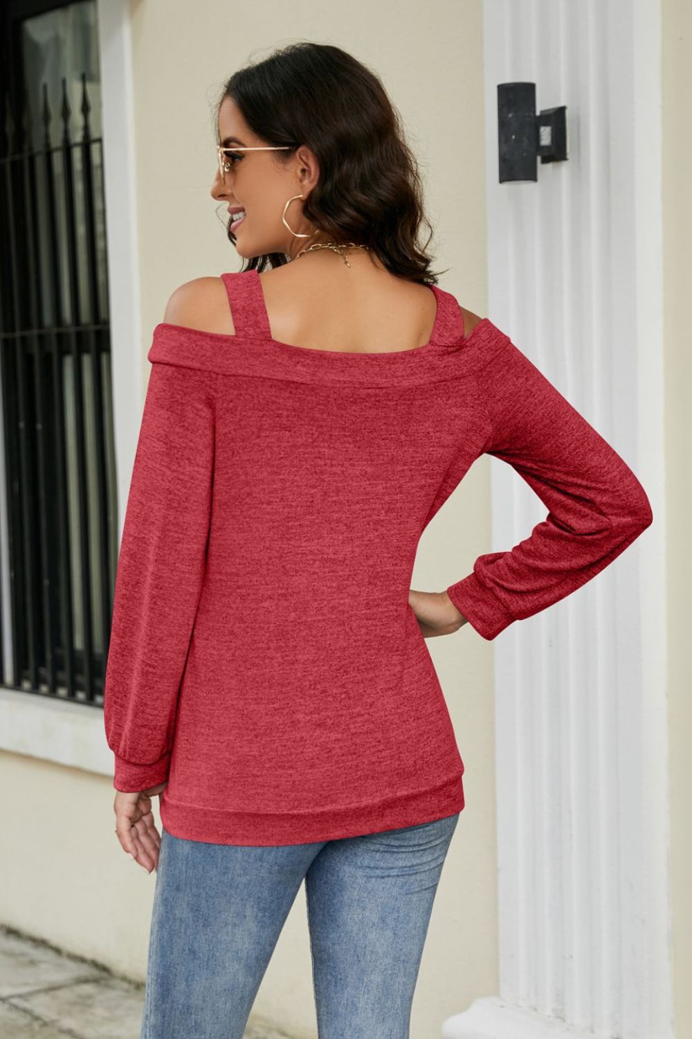 Red sweater with cold shoulder cutouts and long sleeves