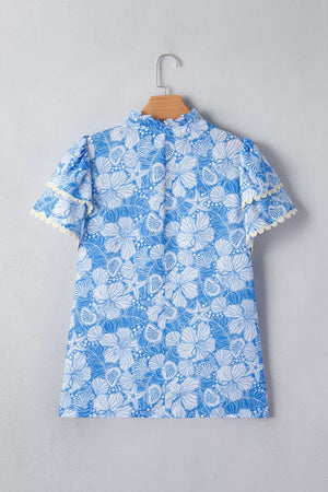 Blue floral print polyester blouse with frill neckline and scalloped sleeves.