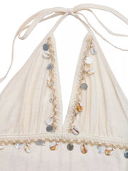 Bohemian halter maxi dress in apricot with shell and sequin trim.