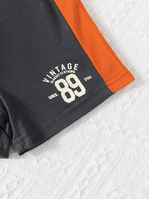 Color block baby set with "Vintage 89" graphic and orange sleeve detail.