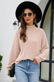 Textured turtleneck sweater in blush pink with long sleeves and a relaxed fit.