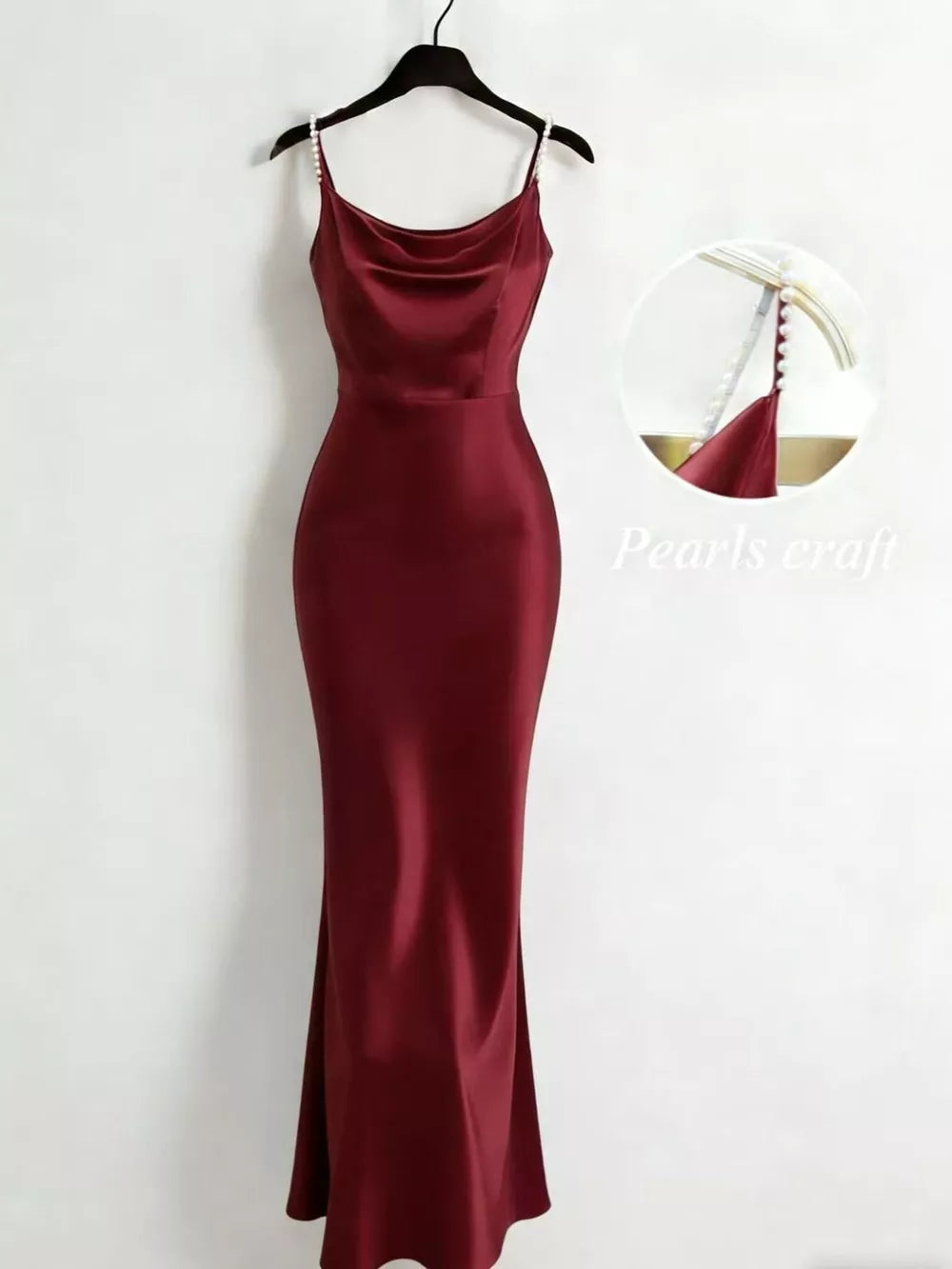 Burgundy satin cowl neck maxi dress with pearl-embellished straps.