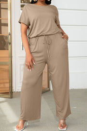 Relaxed fit jumpsuit in tan with short sleeves, drawstring waist, and wide legs.