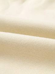 Beige cotton joggers with a soft, textured knit fabric detail.