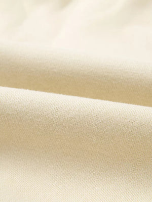 Beige cotton joggers with a soft, textured knit fabric detail.