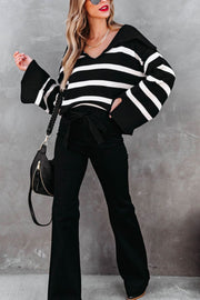 Black and white striped knit sweater with wide collar and bell sleeves.