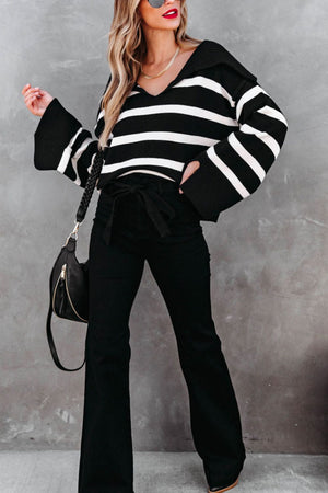 Black and white striped knit sweater with wide collar and bell sleeves.