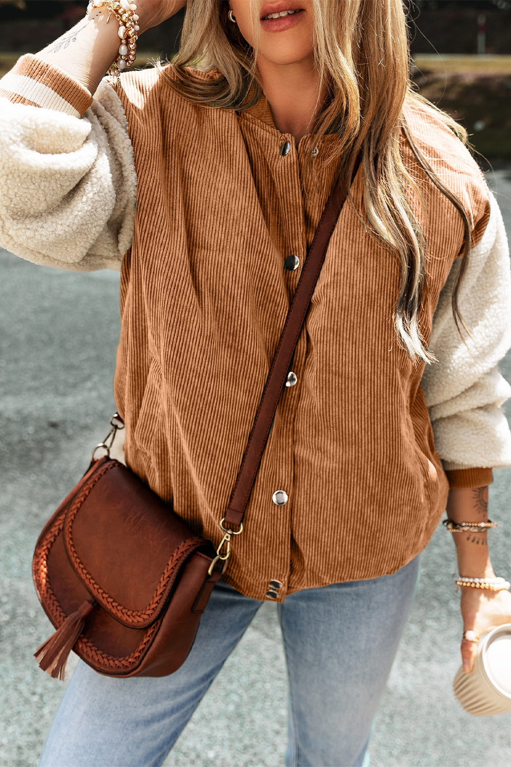 Corduroy bomber jacket in Terracotta with sherpa sleeves and contrast striped cuffs.