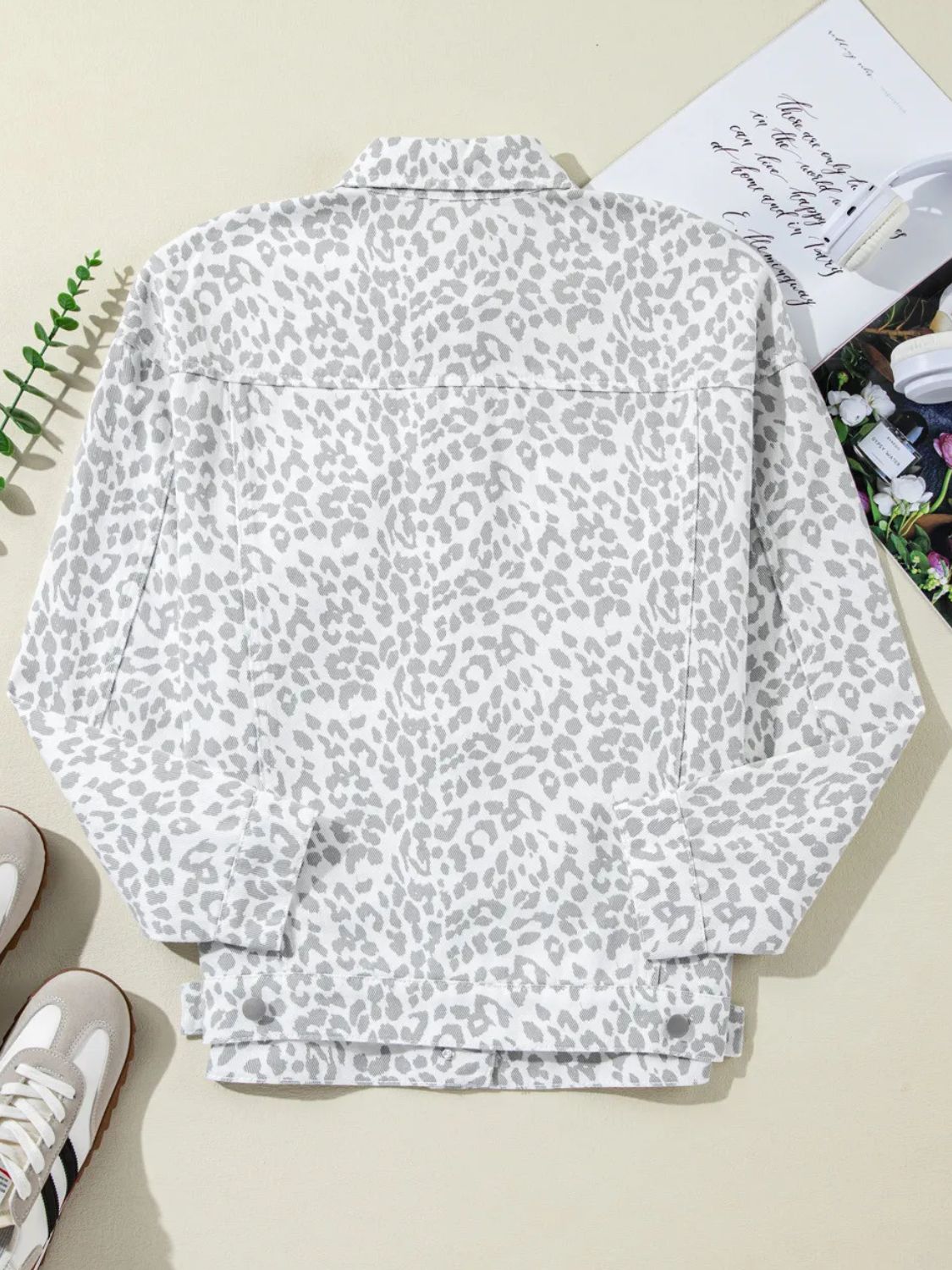 White stone washed leopard print denim jacket with button front and collar.