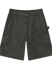 Utility denim carpenter shorts in washed olive with large front pockets and a hammer loop detail.